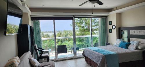 a bedroom with a bed and a large window at Cozy and Modern in Cancún