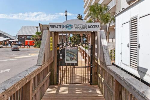 an entrance to a building with a wooden fence at Stunning Gulf View Condo - Direct Beach Access - Stunning Sunsets in Panama City Beach