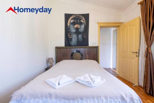 a bedroom with a bed with two towels on it at Villa Mountain with Pool in Gedeller