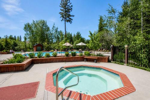 a pool with a hot tub in a yard at Spring Mountain Condo Pool Gym Slopes in McCall