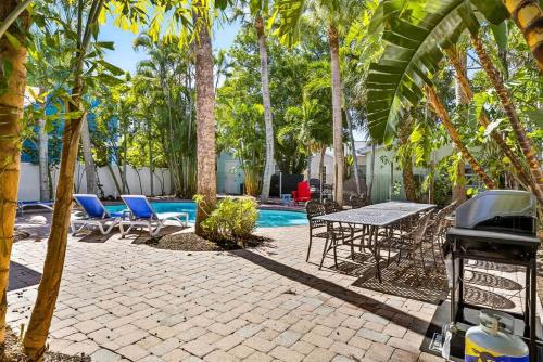 a patio with chairs and a table and a pool at Lantana Cabana in Clearwater Beach