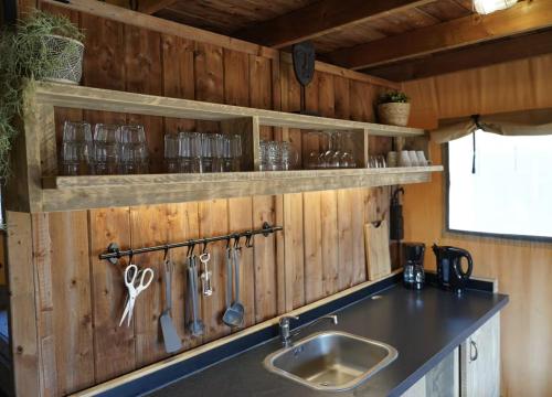 a kitchen with wooden walls and a sink and scissors at F1 Weekend House Close to Spa 6 Guests Doc in Amblève