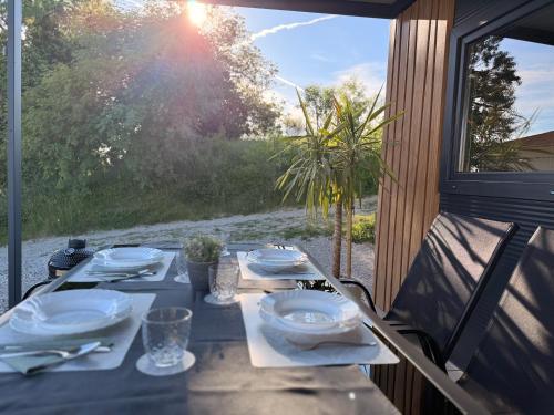 a table with plates and napkins on top at Mobile House Aurora with whirlpool in Ankaran
