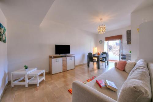 a living room with a couch and a table at Sicilian Charm close to Taormina - Happy Rentals in Gaggi