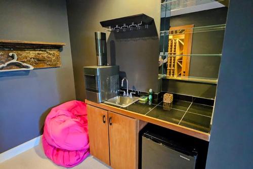 a kitchen with a pink ottoman next to a sink at Partridge Hill House in Hartford