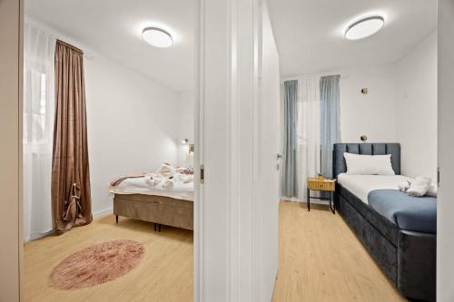 a bedroom with a bed and a table and a bed sqor at New luxury apartment RABASOL in Rabac