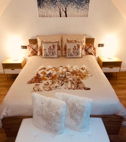 a bedroom with a large white bed with two tables at Eden aux hirondelles in Samer