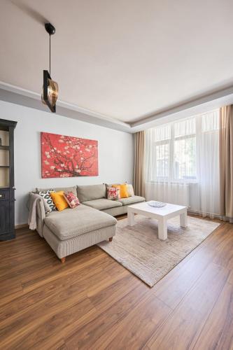 a living room with a couch and a table at Kaira Homes 1 in Ankara
