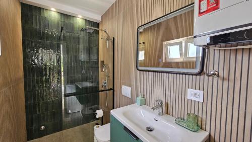 a bathroom with a sink and a shower and a toilet at Apartment Rose Garden in Risan