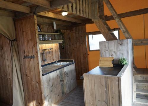 a kitchen with wooden walls and a sink and a counter at F1 Ardennes Stay 5p Parking Bashfull in Amblève