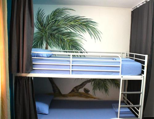 a bunk bed with a palm tree on it at TravelBreak in Podgorica