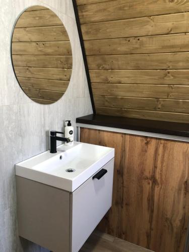 a bathroom with a white sink and a mirror at Frame&Forest2 in Kolochava