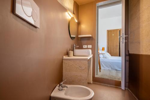 a bathroom with a sink and a mirror and a bed at Serena Armando Exclusive Villas with Private Pools in Rosa Marina