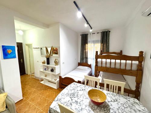 a small bedroom with a bed and a table and chairs at Joni's Beach Apartments - Spille in Spille