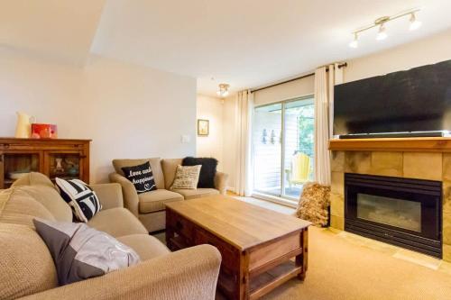 a living room with a couch and a fireplace at 09 Valhalla in Whistler