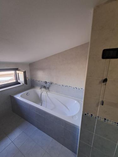a large bathroom with a tub and a shower at Casa Panorama Assisi in Perugia