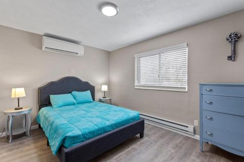a bedroom with a bed and a dresser and a window at Private 1BR for Two on Morganford in Saint Louis