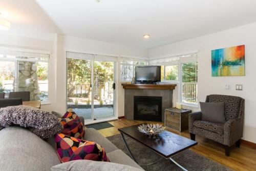 a living room with a couch and a fireplace at 63 Lagoons in Whistler