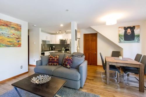 a living room with a couch and a table at 63 Lagoons in Whistler