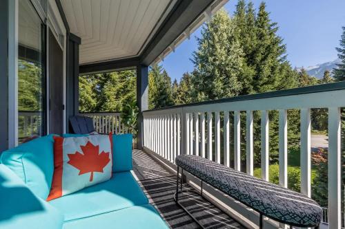 a screened in porch with a bench on it at Panoramic Views from this gorgeous 2 Bed Property - Village Location in Whistler