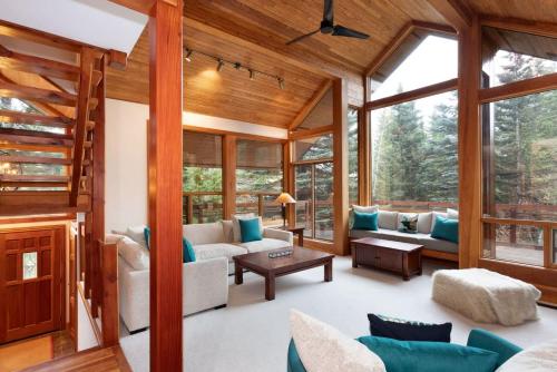 a living room with a lot of windows at Luxury 5 Bedroom Blueberry Chalet in Whistler