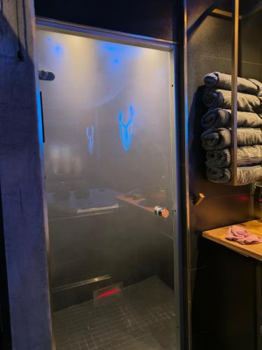 a glass door of a shower in a room at Luxuria - Jacuzzi et Hammam in Le Cannet