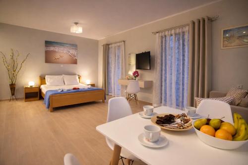 a room with a bed and a table with fruit on it at Nikoletta 4 in Vlachopoulátika