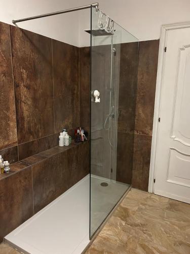 a shower with a glass enclosure in a bathroom at Franciacorta Garden House in Cazzago San Martino