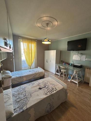 a room with two beds and a table in it at Franciacorta Garden House in Cazzago San Martino