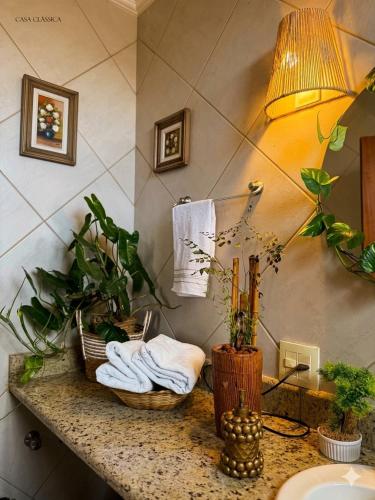 a bathroom with a sink and towels on a counter at Suite casal 2 com frigobar in Belo Horizonte