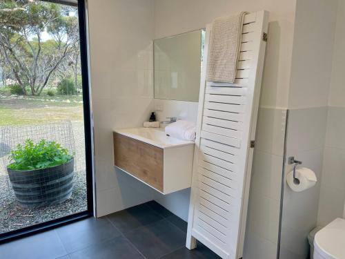 a bathroom with a sink and a mirror at Stokes Bay Cliffs Kangaroo Island in Stokes Bay