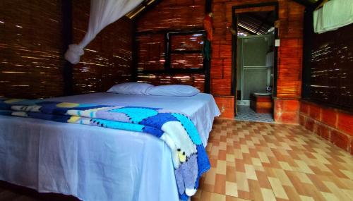 a bedroom with a bed in a room at Ecopradera Lodge in San José del Guaviare