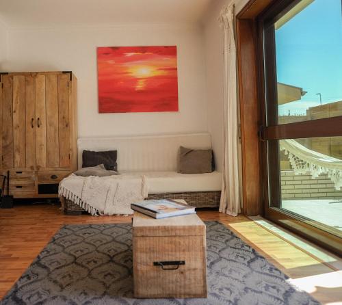 a living room with a bed and a large window at Step by Step Atlantic Guesthouse in Vila do Conde