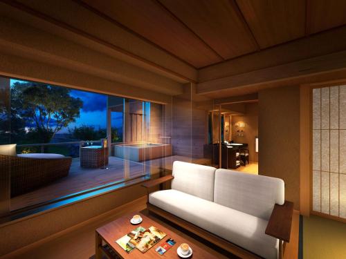 a living room with a white couch and a large window at Kobe Bay Sheraton Hotel & Towers in Kobe