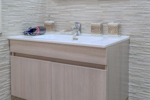 a bathroom counter with a sink and two towels at COZY APPARTEMENT Center city 11 janvier in Casablanca