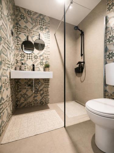 a bathroom with a shower stall and a toilet at Apartments Casa al Vento in Donja Klada