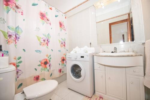 a bathroom with a washing machine and a sink at Ocean Paradise View in Adeje