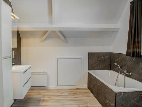 a bathroom with a large tub and a sink at Lac Bleu 16 in Lacapelle-Marival