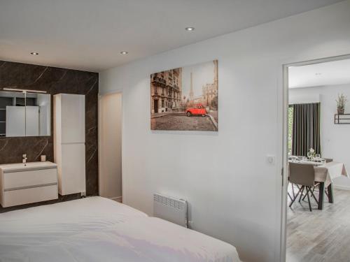 a bedroom with a white bed and a red car on the wall at Lac Bleu 16 in Lacapelle-Marival