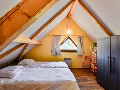 a attic bedroom with a bed and a window at Lac Bleu huis nr 13 in Lacapelle-Marival