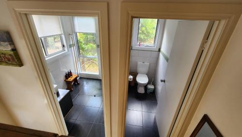 an overhead view of a bathroom with a toilet and windows at Tarndwarncoort Homestead in Warncoort