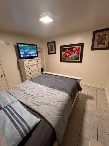 a bedroom with a bed and a flat screen tv at Downtown Purple Apartment in Phoenix