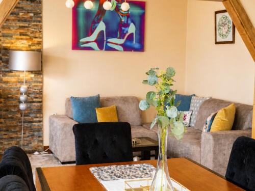 a living room with a couch and a table at Vivenda Portela in Covelinhas