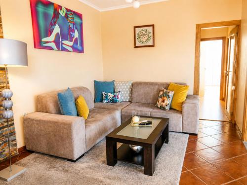 a living room with a couch and a coffee table at Vivenda Portela in Covelinhas
