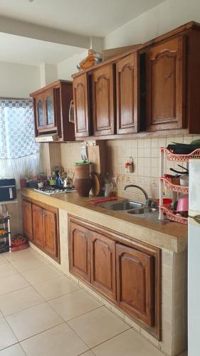a kitchen with wooden cabinets and a sink at Sweet Room in Casa in Casablanca