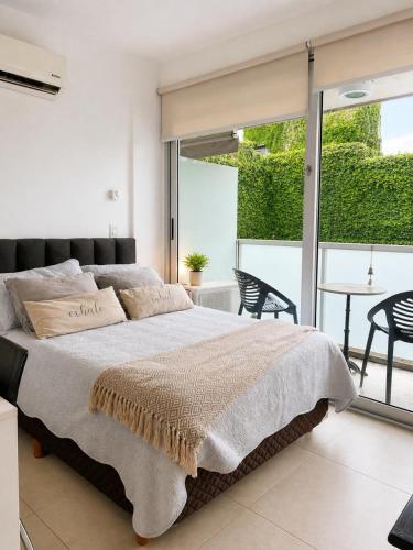 a bedroom with a large bed and a table and chairs at Lezama Park ll in Buenos Aires