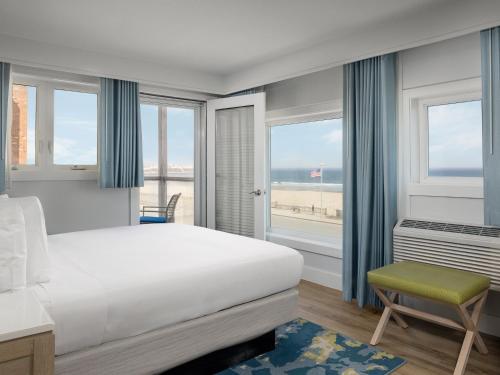 a bedroom with a bed and a view of the ocean at Ashworth by the Sea in Hampton