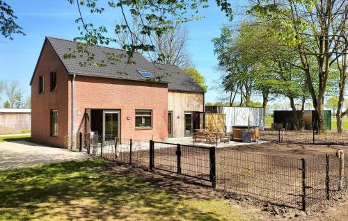 a brick house with a fence in front of it at 5 Bedroom Luxurious Home In Afferden in Afferden