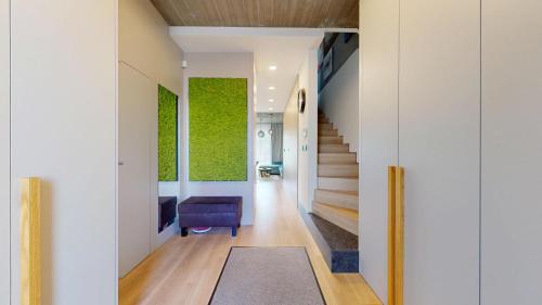 a hallway of a house with green walls at Vila Golf & Relax, Hrubá Borša in Hrubá Borša