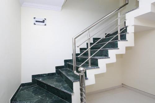 a staircase with green marble treads in a house at Hotel O Atithi Home Stay in Garhā